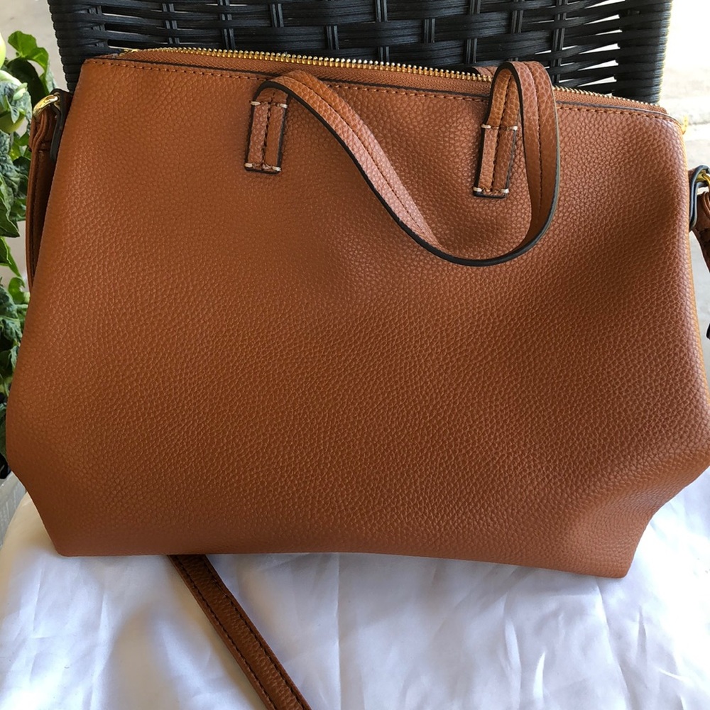 Tan bonded leather handbag .